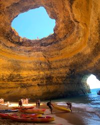 People in cave at beach