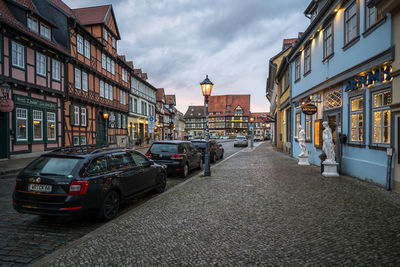 Cars on street amidst buildings in city