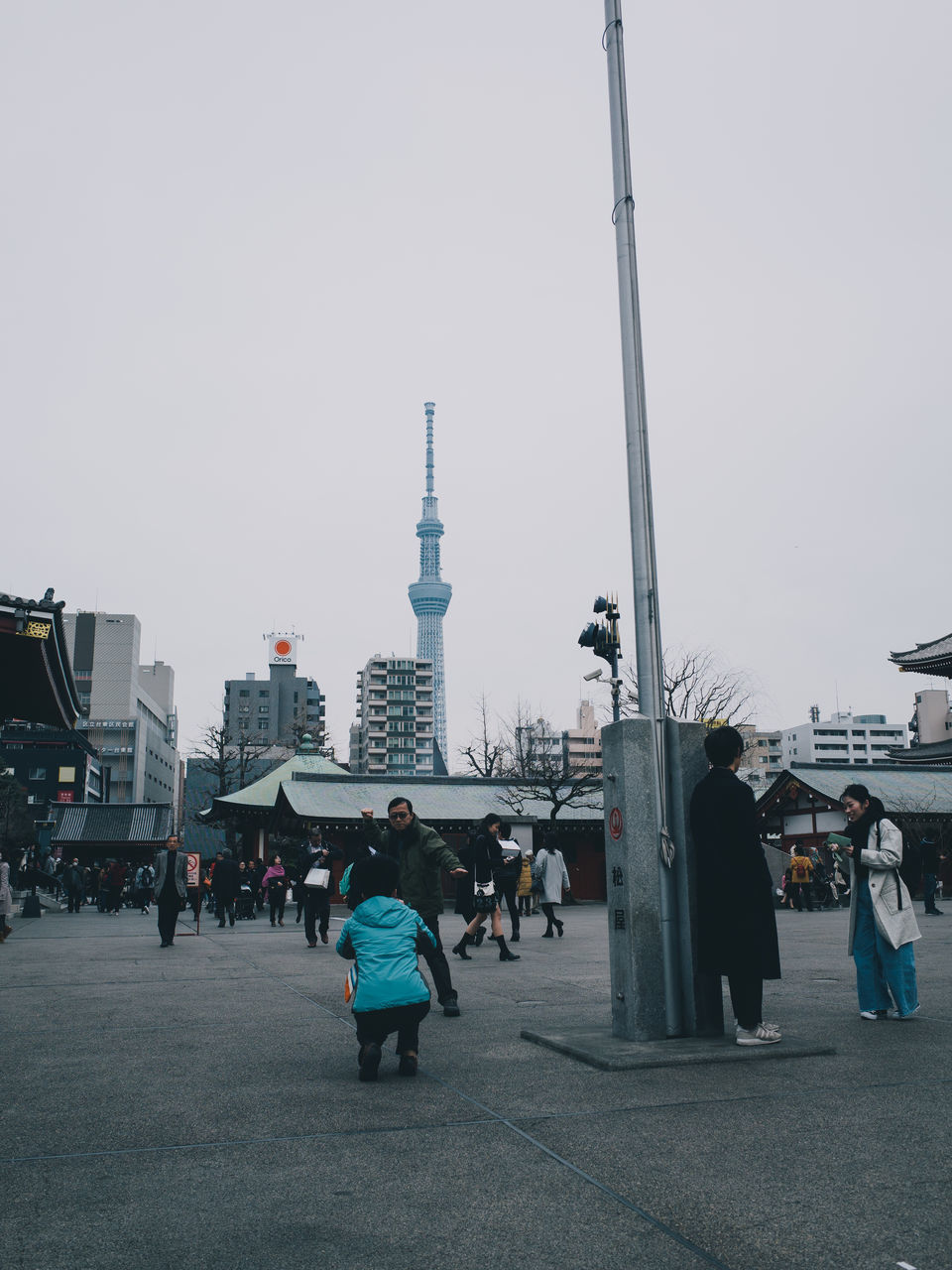 GROUP OF PEOPLE IN FRONT OF BUILDINGS