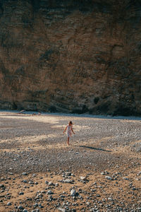 Rear view of man walking on beach