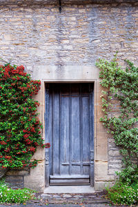 Doorway in castle combe, quaint village with well preserved masonry houses. cotswolds in england, uk