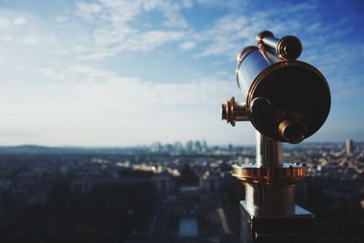 Close-up of security camera against sky