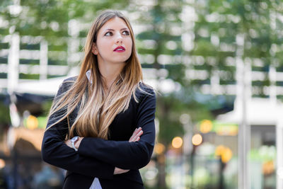 Portrait of beautiful young woman standing outdoors