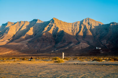 Scenic view of mountains against clear blue sky