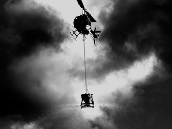 Low angle view of helicopter flying against sky