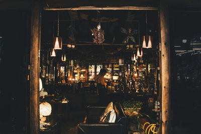 People in restaurant by illuminated building