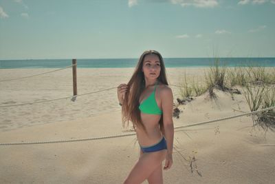 Young woman standing on beach 