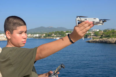 Portrait happy teenage  preparing and finalizing flight details for drone flight technology concept