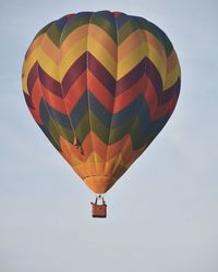 Low angle view of hot air balloons against blue sky