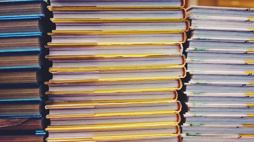 Full frame shot of books stacked indoors