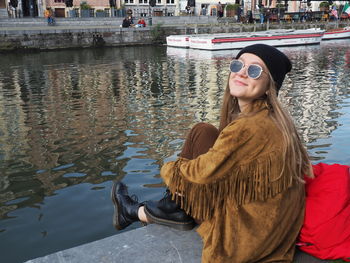 Young woman wearing sunglasses in water