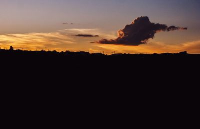 Scenic view of silhouette field against sky during sunset