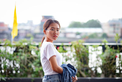 Portrait of woman standing in city