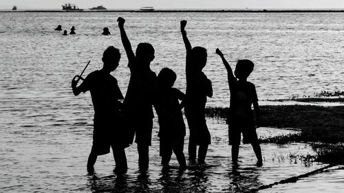 Silhouette people at beach