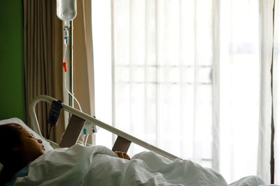 Close-up of man relaxing on bed