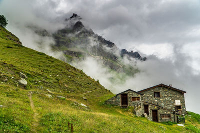 Scenic view of houses on mountain against sky