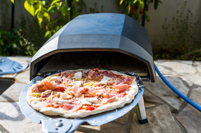 Close-up of pizza on table in yard