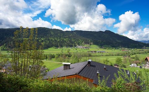 Scenic view of landscape and houses against sky