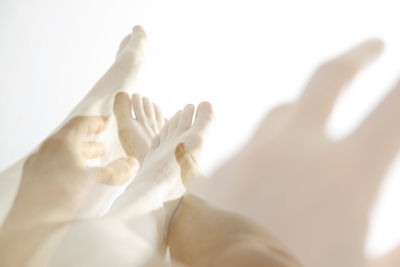 Close-up of hand touching sand at beach