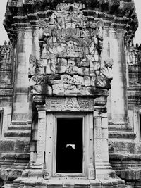 Low angle view of statue against temple