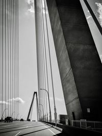 Low angle view of suspension bridge against sky