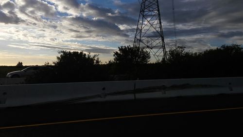 Silhouette of trees against cloudy sky