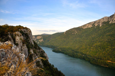 High angle view of river amidst mountains against sky