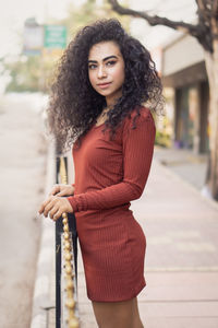 Portrait of beautiful young woman standing outdoors