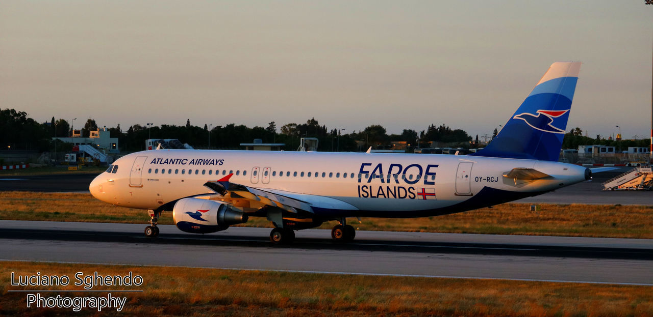 AIRPLANE ON AIRPORT RUNWAY