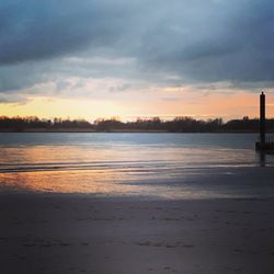 Scenic view of beach against sky during sunset