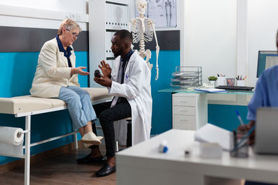 Doctor examining patient in clinic