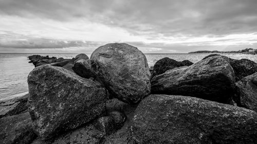 Rocks on beach against sky