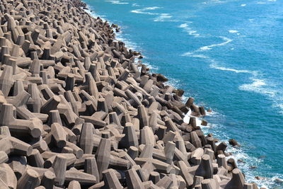 High angle view of tetrapods on beach against sky