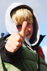 Portrait of boy gesturing thumbs up