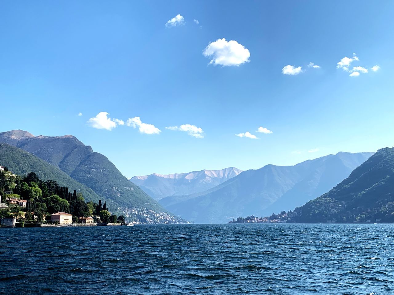 water, beauty in nature, mountain, scenics - nature, waterfront, sky, tranquil scene, cloud - sky, mountain range, tranquility, nature, day, non-urban scene, idyllic, no people, sea, blue, outdoors, architecture, view into land