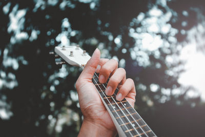 Close-up of hand playing guitar