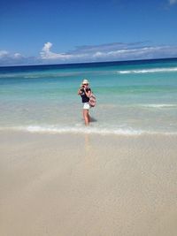 Full length of man standing on beach against sky