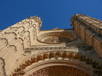 Low angle view of building against clear blue sky