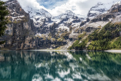 The view of oeschinenee lake and oeschinen valley amongst bernese alps mountain tops. 