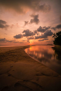 Scenic view of beach against sky during sunset