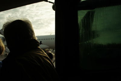 Woman looking through window