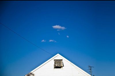 High section of house against blue sky