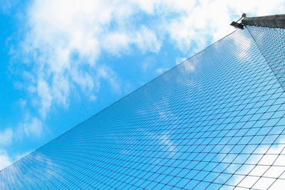 Low angle view of modern building against blue sky