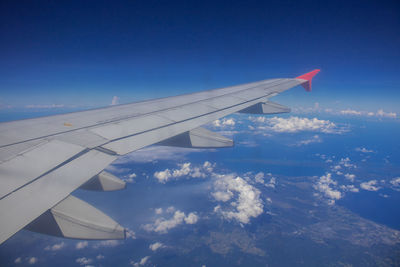 Aerial view of airplane flying in sky