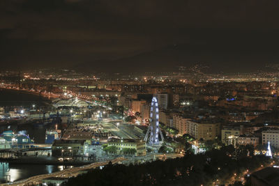 High angle view of illuminated buildings in city at night