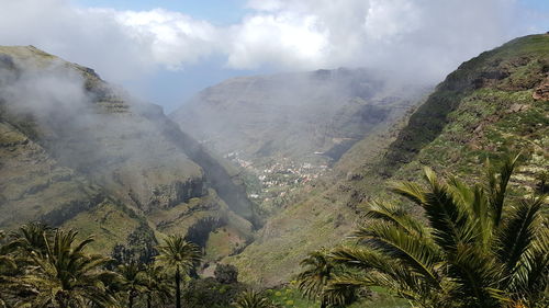 Scenic view of mountains against cloudy sky