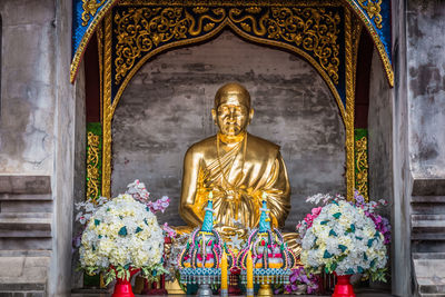 The golden statue of monk at wat den salee sri muang gan or wat ban den, temple in north of thailand