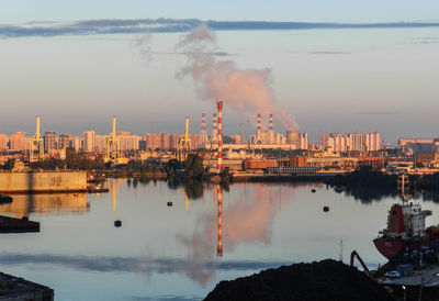 Smoke emitting from factory against clear sky