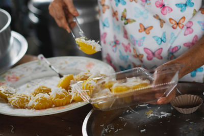 Midsection of person preparing food