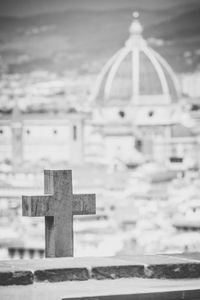 Close-up of cross in cemetery against sky